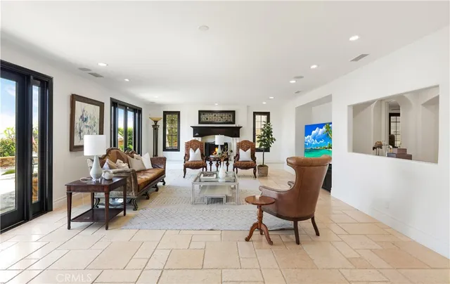 a dining room with furniture a chandelier and window