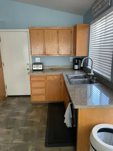 a kitchen with a sink a stove and cabinets