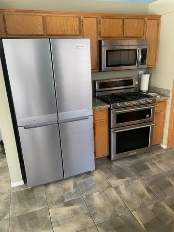 a kitchen with a refrigerator stove and microwave
