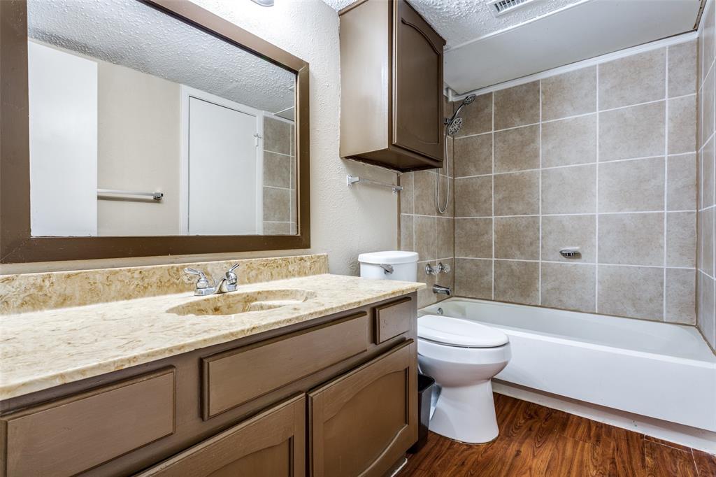 3022 Forest Lane, Unit 218 Dallas, TX 75234 - Photo 13 of 14 a bathroom with a sink toilet and shower