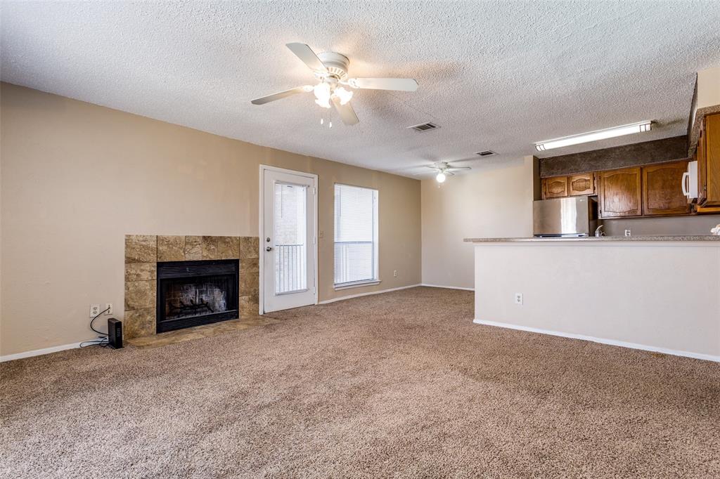 3022 Forest Lane, Unit 218 Dallas, TX 75234 - Photo 4 of 14 a view of a kitchen with a sink and a fireplace