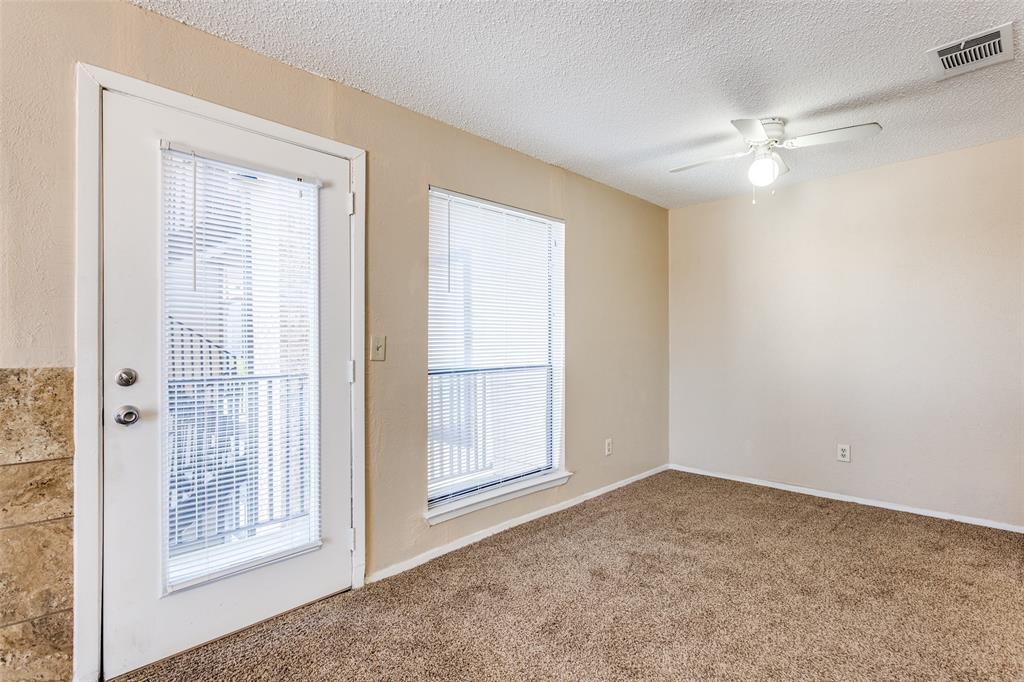 3022 Forest Lane, Unit 218 Dallas, TX 75234 - Photo 6 of 14 a view of an empty room with a window
