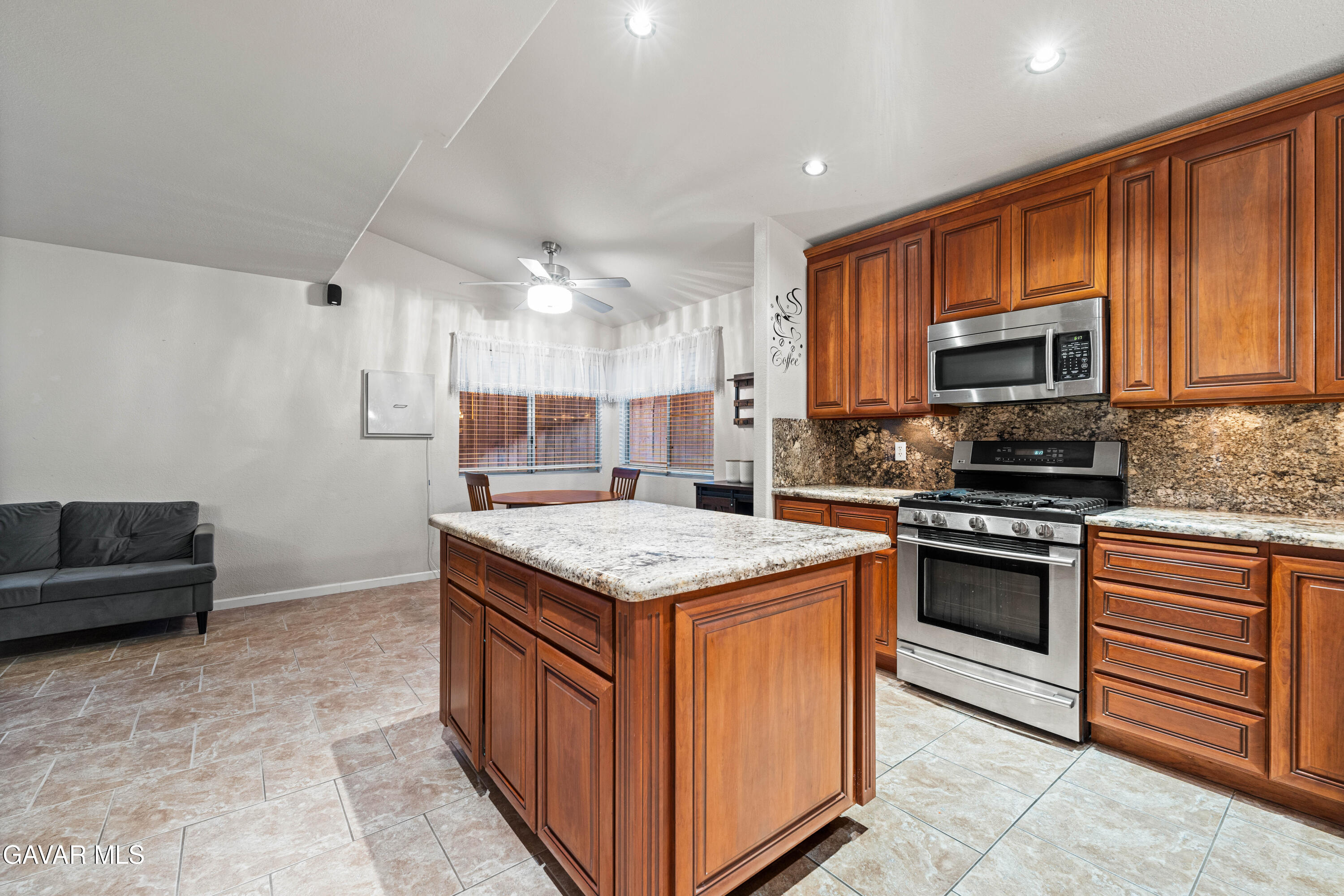 3418 Rodney Street Rosamond, CA 93560 - Photo 11 of 35 a kitchen with stainless steel appliances granite countertop a stove top oven a sink and a microwave