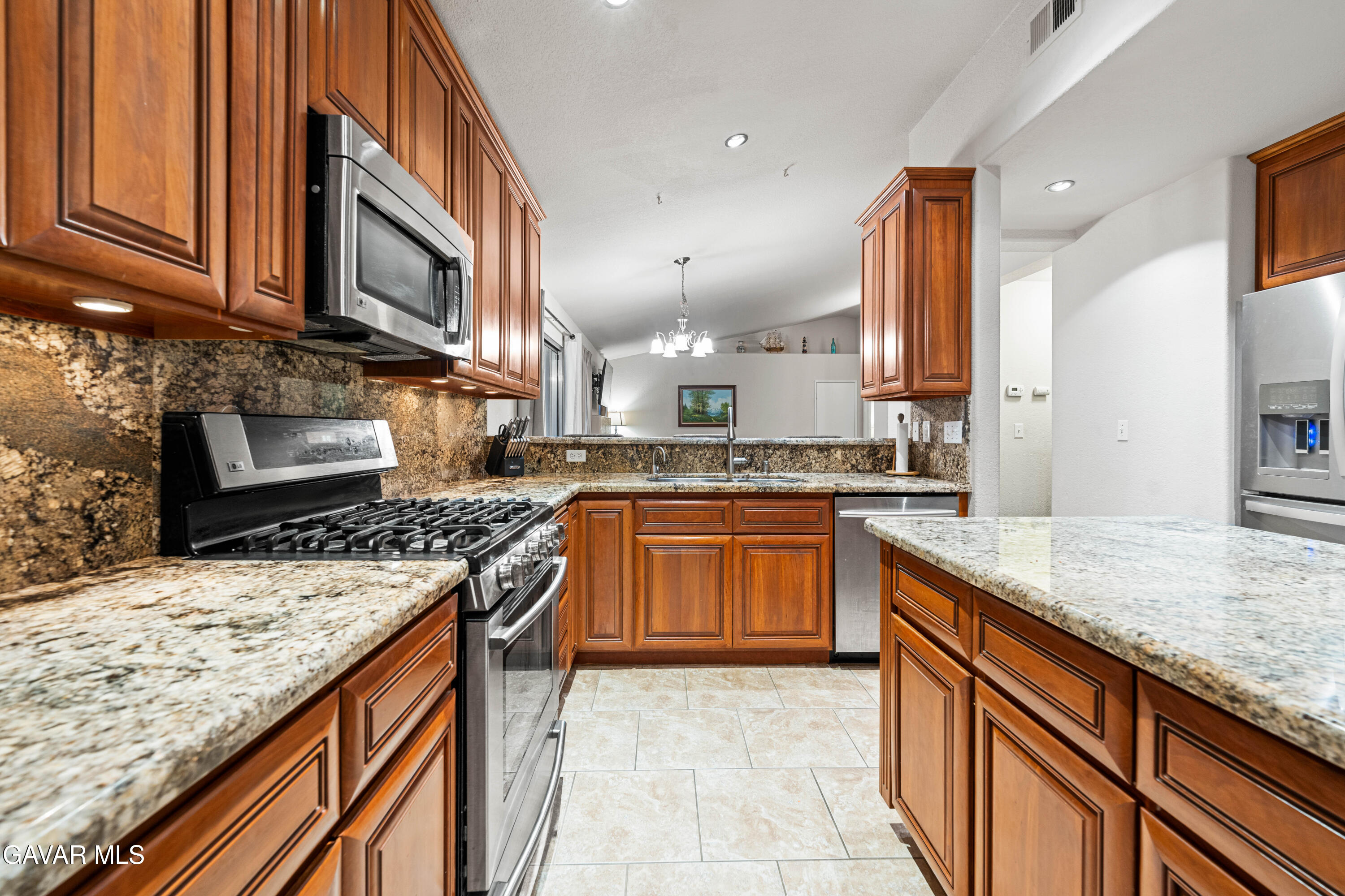3418 Rodney Street Rosamond, CA 93560 - Photo 13 of 35 a kitchen with stainless steel appliances granite countertop a stove a sink and a microwave