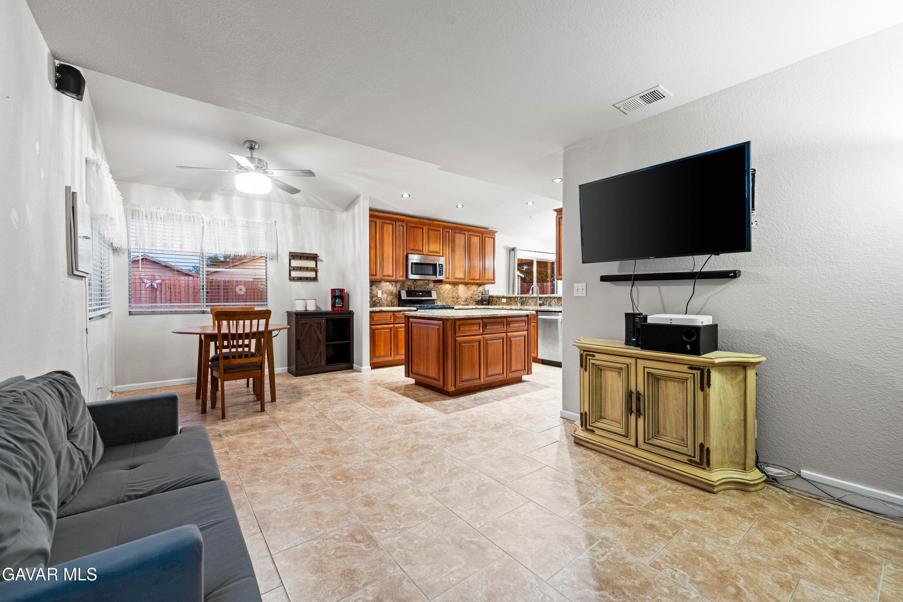 3418 Rodney Street Rosamond, CA 93560 - Photo 18 of 35 a living room with stainless steel appliances furniture and a flat screen tv