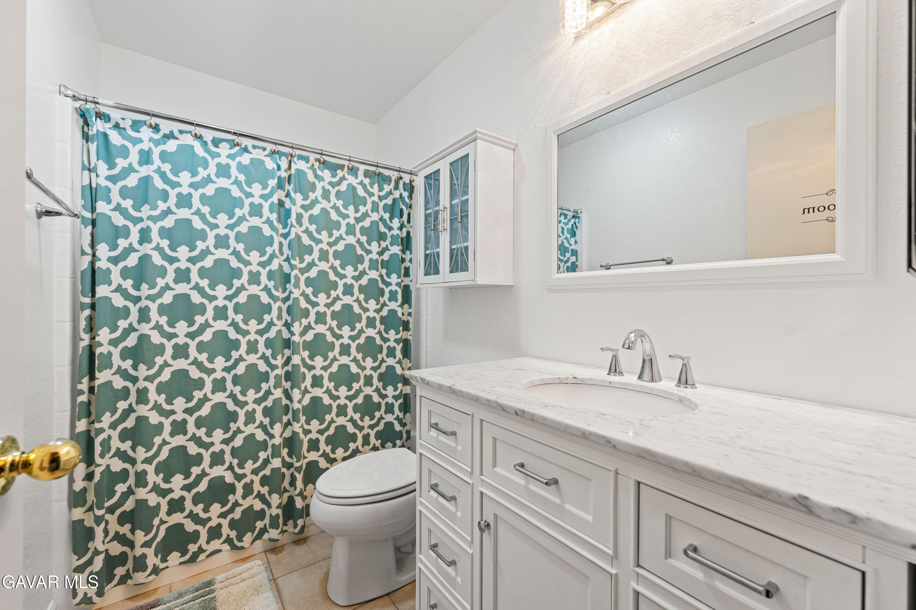 3418 Rodney Street Rosamond, CA 93560 - Photo 23 of 35 a bathroom with a granite countertop sink a toilet and a mirror