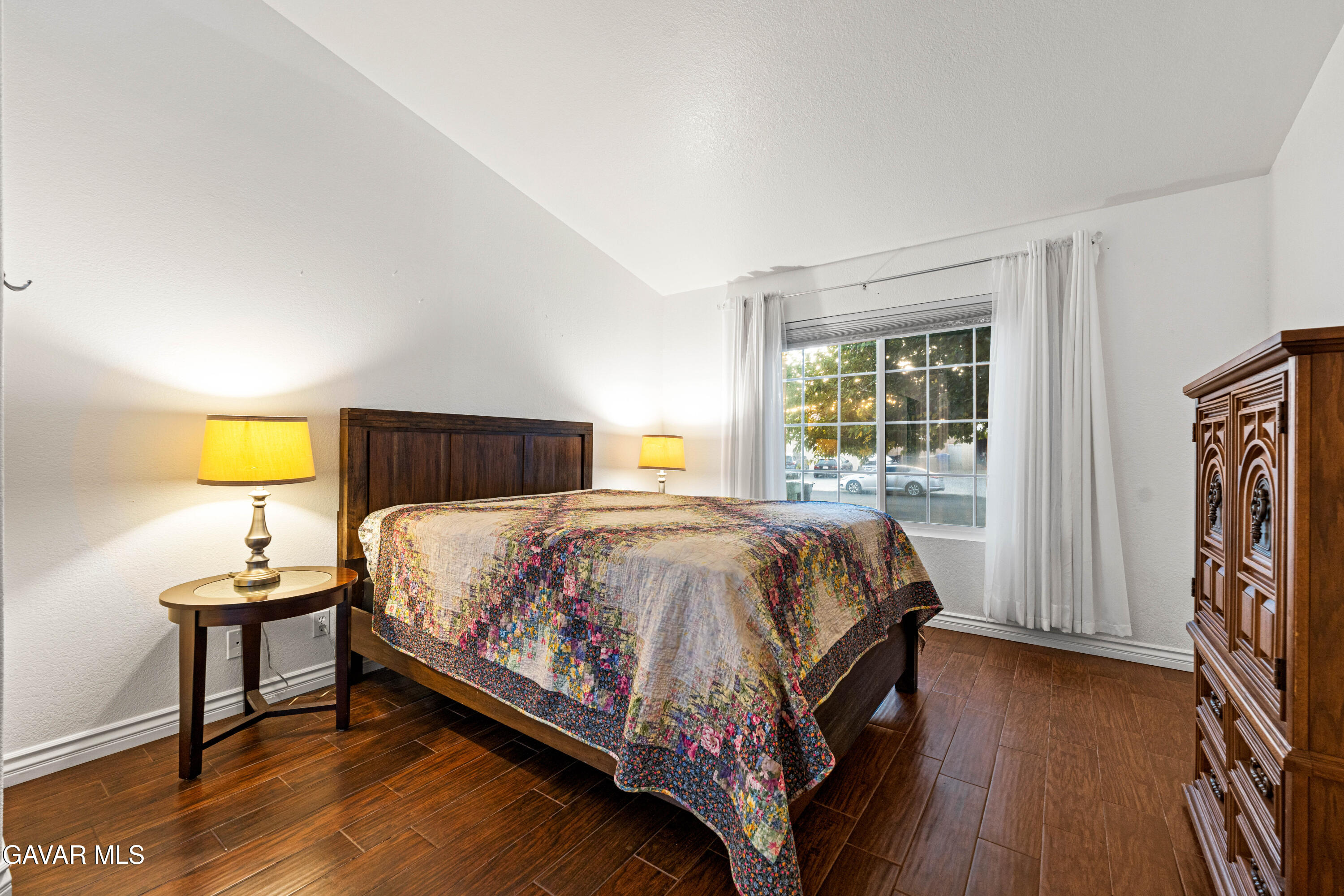 3418 Rodney Street Rosamond, CA 93560 - Photo 24 of 35 a bedroom with a bed and wooden floor