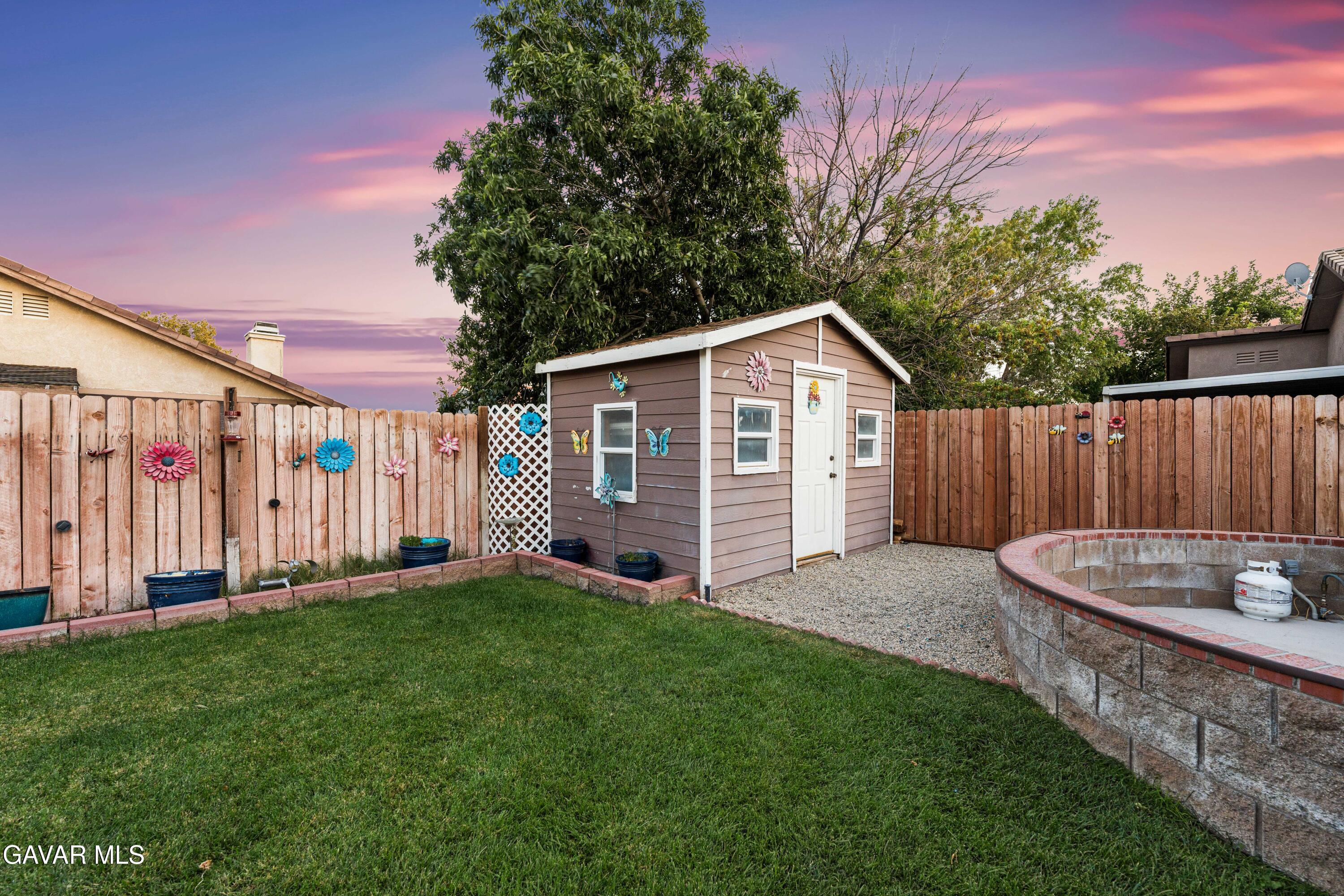 3418 Rodney Street Rosamond, CA 93560 - Photo 31 of 35 a view of a backyard with a small cabin and chair
