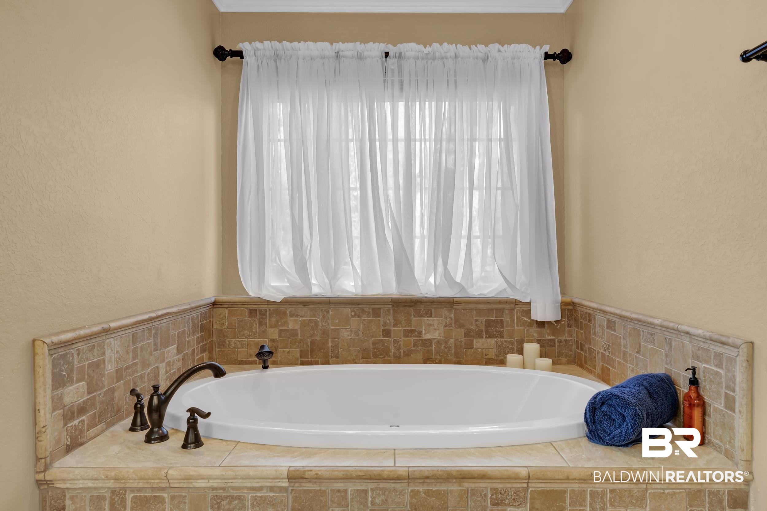 22929 Highway 98 Foley, AL 36535 - Photo 20 of 54 Bathroom featuring a garden tub, crown molding, and a textured wall