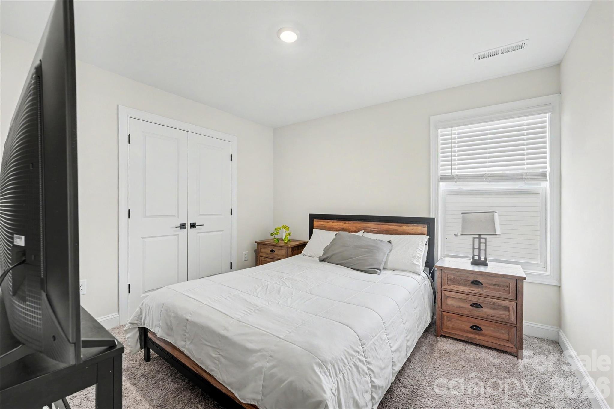 123 Brixham Loop Troutman, NC 28166 - Photo 12 of 18 a bedroom with a bed and a mirror