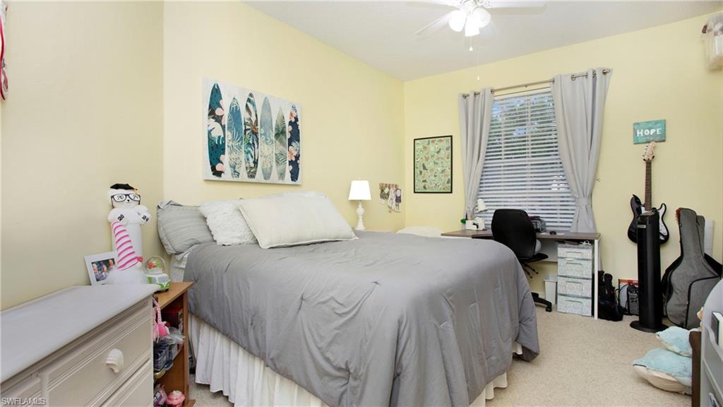 96 Silver Oaks Circle, Unit 1202 Naples, FL 34119 - Photo 14 of 30 a bedroom with bed and a large mirror