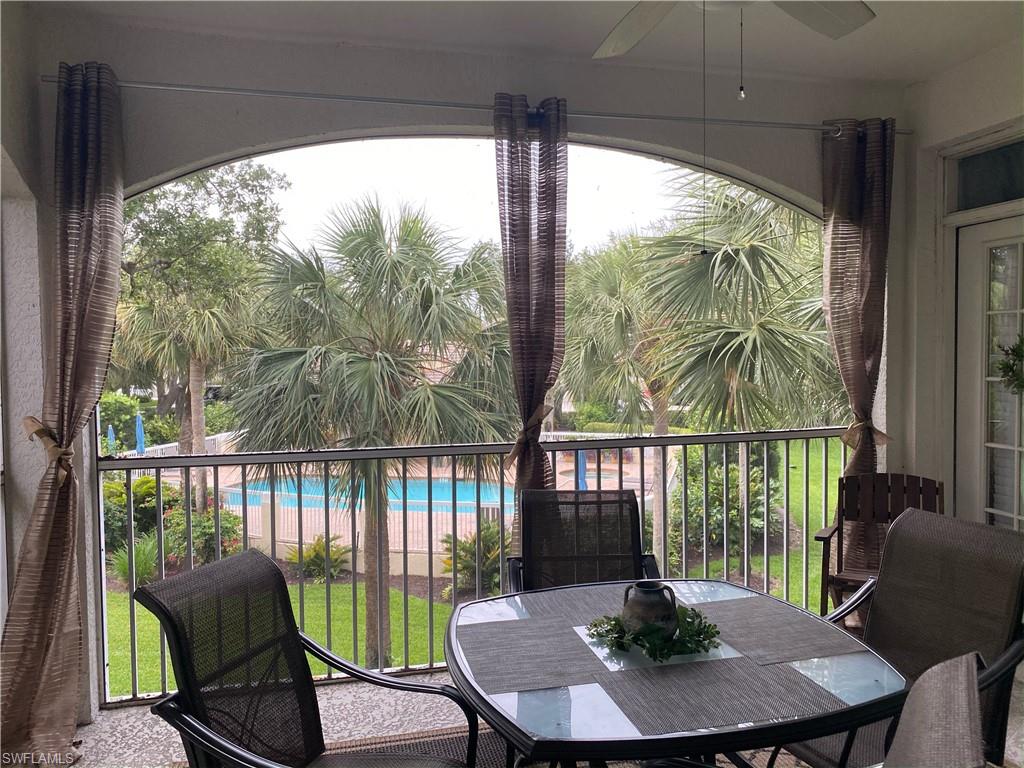 96 Silver Oaks Circle, Unit 1202 Naples, FL 34119 - Photo 17 of 30 a view of a chairs and table in patio