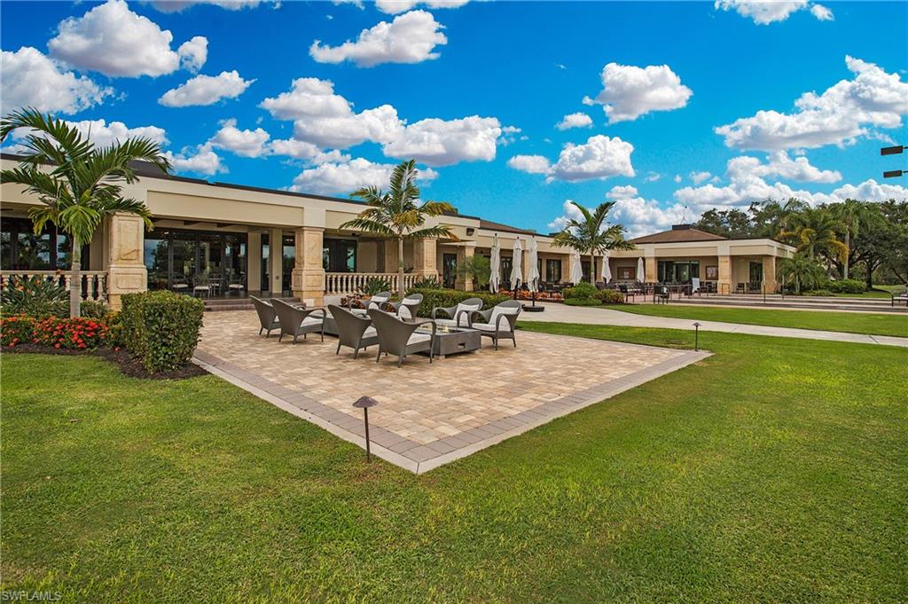 96 Silver Oaks Circle, Unit 1202 Naples, FL 34119 - Photo 25 of 30 a view of a house with a garden
