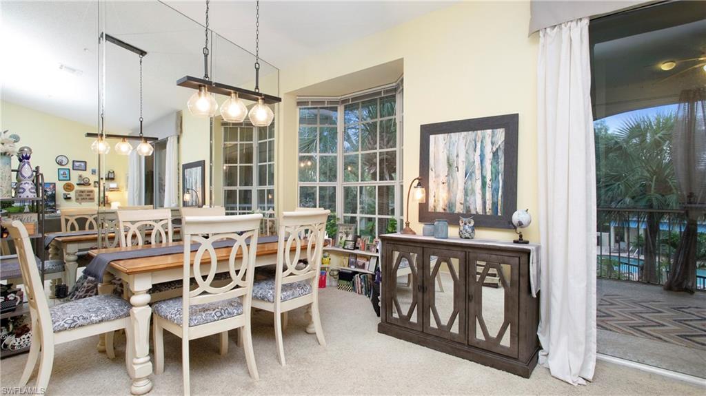 96 Silver Oaks Circle, Unit 1202 Naples, FL 34119 - Photo 7 of 30 a view of a dining room with furniture window and wooden floor