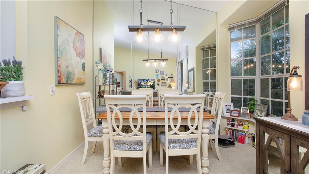 96 Silver Oaks Circle, Unit 1202 Naples, FL 34119 - Photo 8 of 30 a view of a dining room with furniture window and outside view