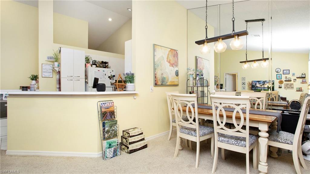 96 Silver Oaks Circle, Unit 1202 Naples, FL 34119 - Photo 9 of 30 a view of a dining room with furniture