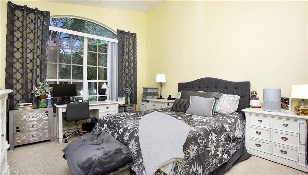 96 Silver Oaks Circle, Unit 1202 Naples, FL 34119 - Photo 10 of 30 a bed room with a bed and a window