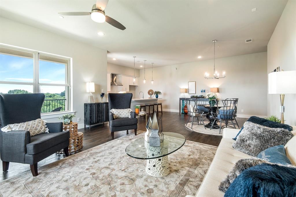 770 North Plano Road, Unit 303 Richardson, TX 75081 - Photo 1 of 26 This open-concept living area features hardwood floors, a ceiling fan, and large windows offering views of the outdoors