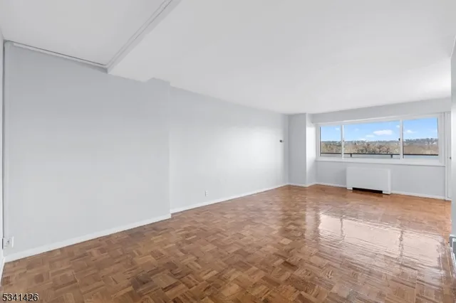 a kitchen with granite countertop white cabinets and stainless steel appliances