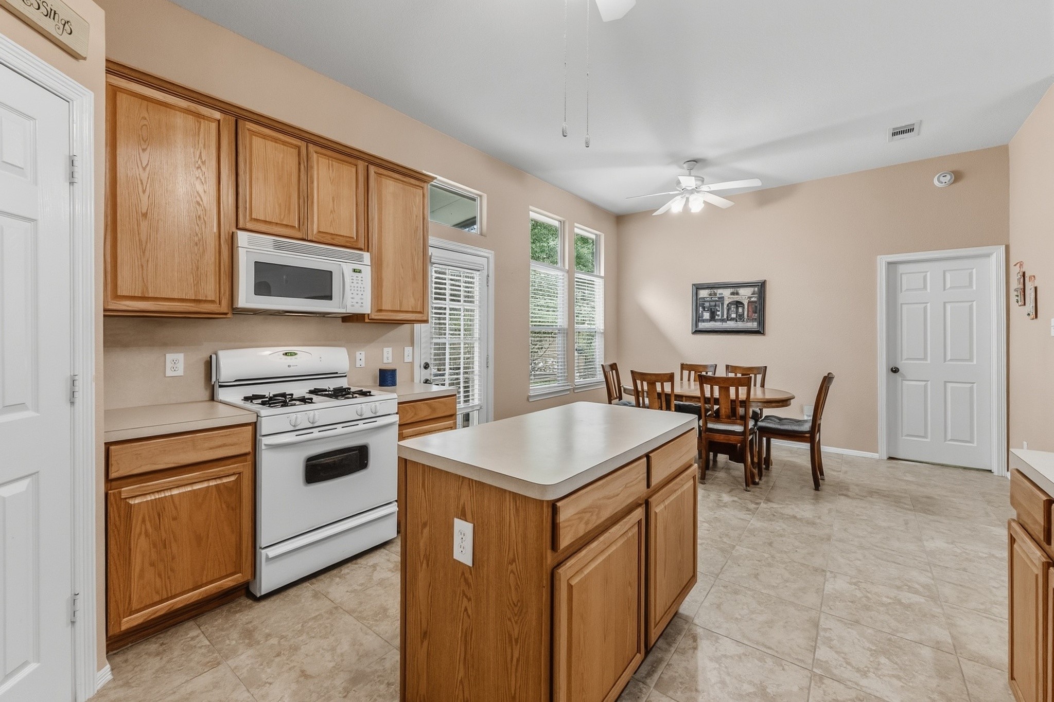 273 Sunset Path South Conroe, TX 77316 - Photo 15 of 45 Eat-in Kitchen accommodates full sized Dining Table. Primary Bedroom ahead through door. 273 Sunset Path S, 77316.