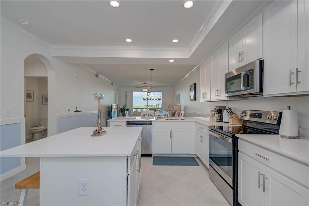 5807 Double Eagle Cir Avenue, Unit 4635 Immokalee, FL 34142 - Photo 12 of 43 a kitchen with sink a microwave and cabinets