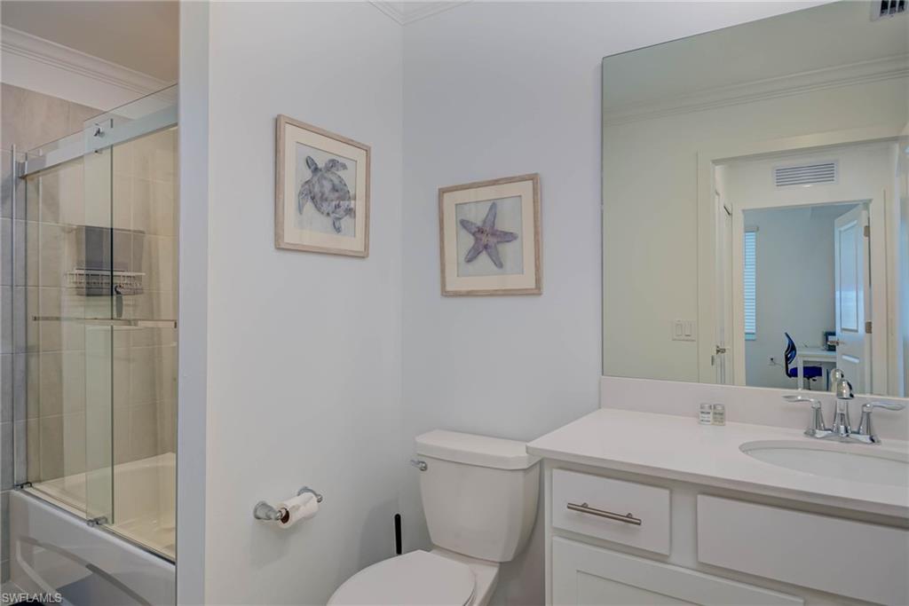 5807 Double Eagle Cir Avenue, Unit 4635 Immokalee, FL 34142 - Photo 19 of 43 a bathroom with a toilet sink vanity and mirror