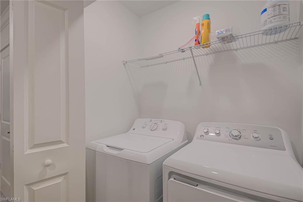5807 Double Eagle Cir Avenue, Unit 4635 Immokalee, FL 34142 - Photo 21 of 43 a utility room with dryer and washer