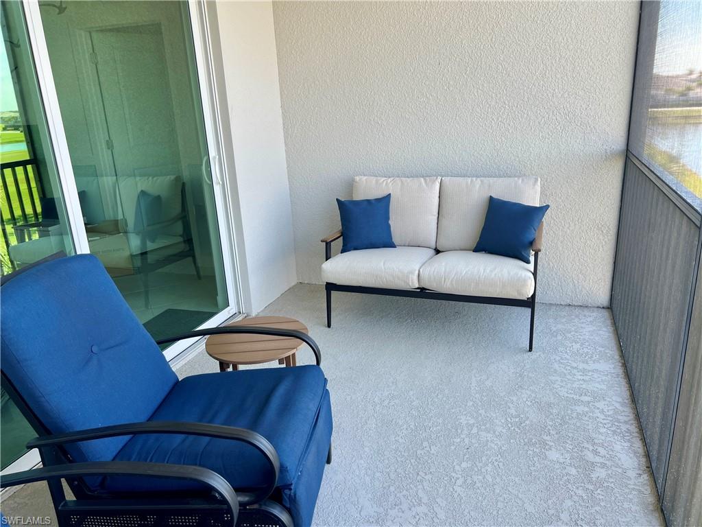 5807 Double Eagle Cir Avenue, Unit 4635 Immokalee, FL 34142 - Photo 25 of 43 a living room with furniture and a rug