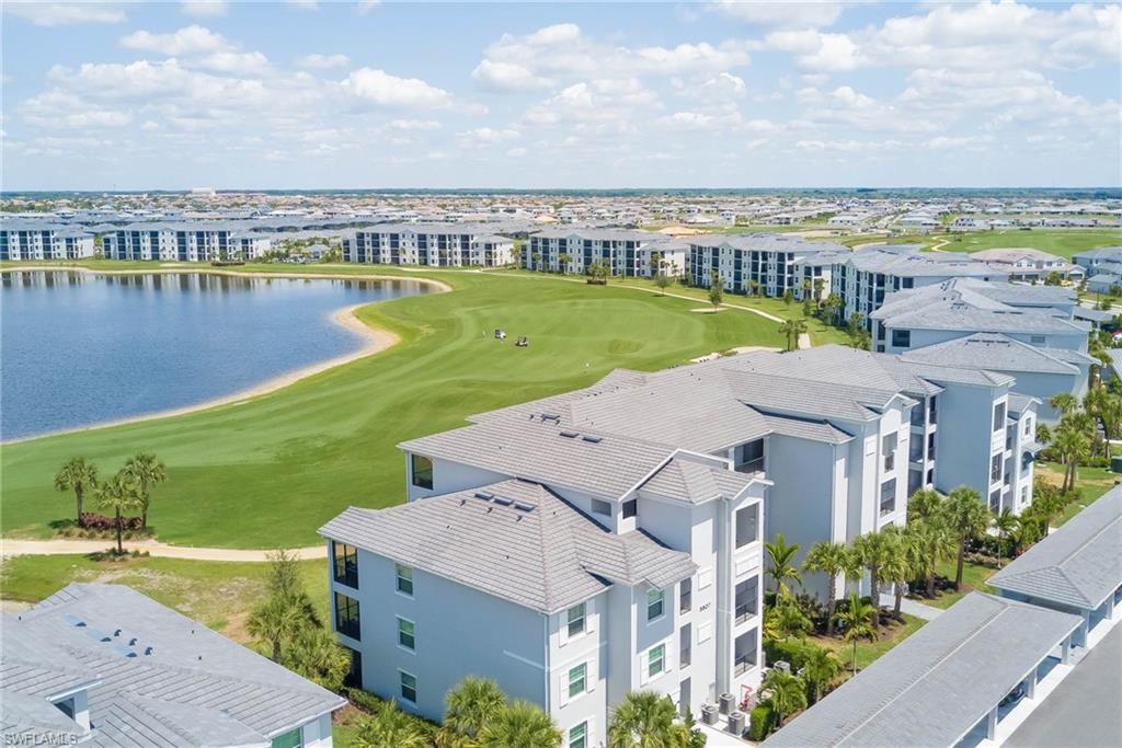 5807 Double Eagle Cir Avenue, Unit 4635 Immokalee, FL 34142 - Photo 30 of 43 an aerial view of a house with a garden and lake view