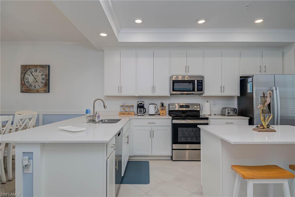 5807 Double Eagle Cir Avenue, Unit 4635 Immokalee, FL 34142 - Photo 10 of 43 a kitchen with stainless steel appliances granite countertop a sink stove and refrigerator