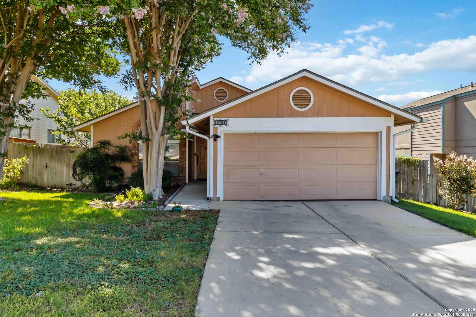 a view of backyard of house with green space