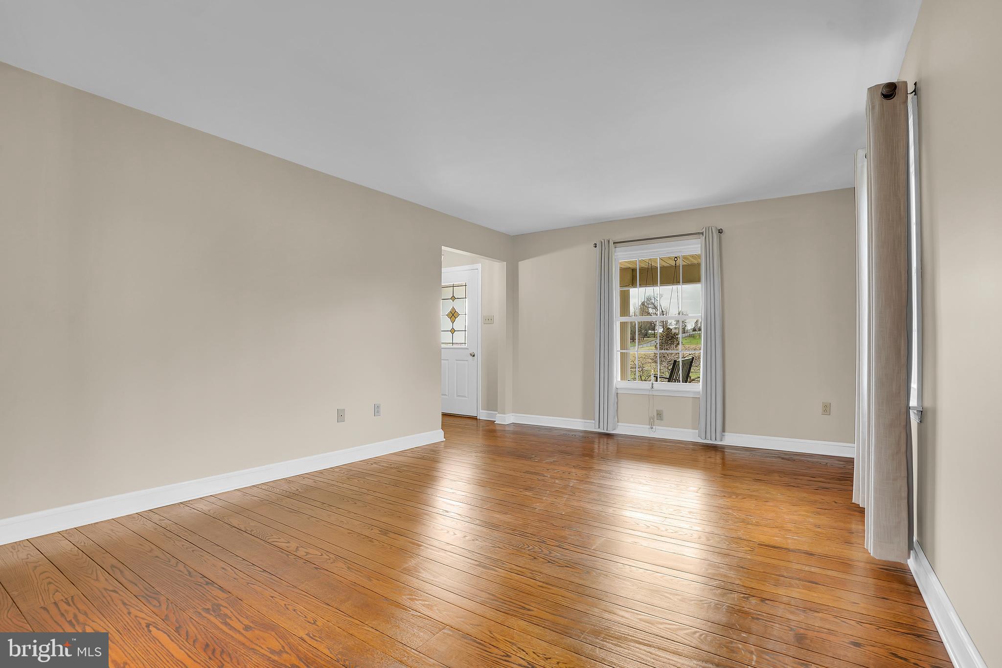 13039 Spickler Road Clear Spring, MD 21722 - Photo 9 of 59 a view of an empty room with wooden floor and a window