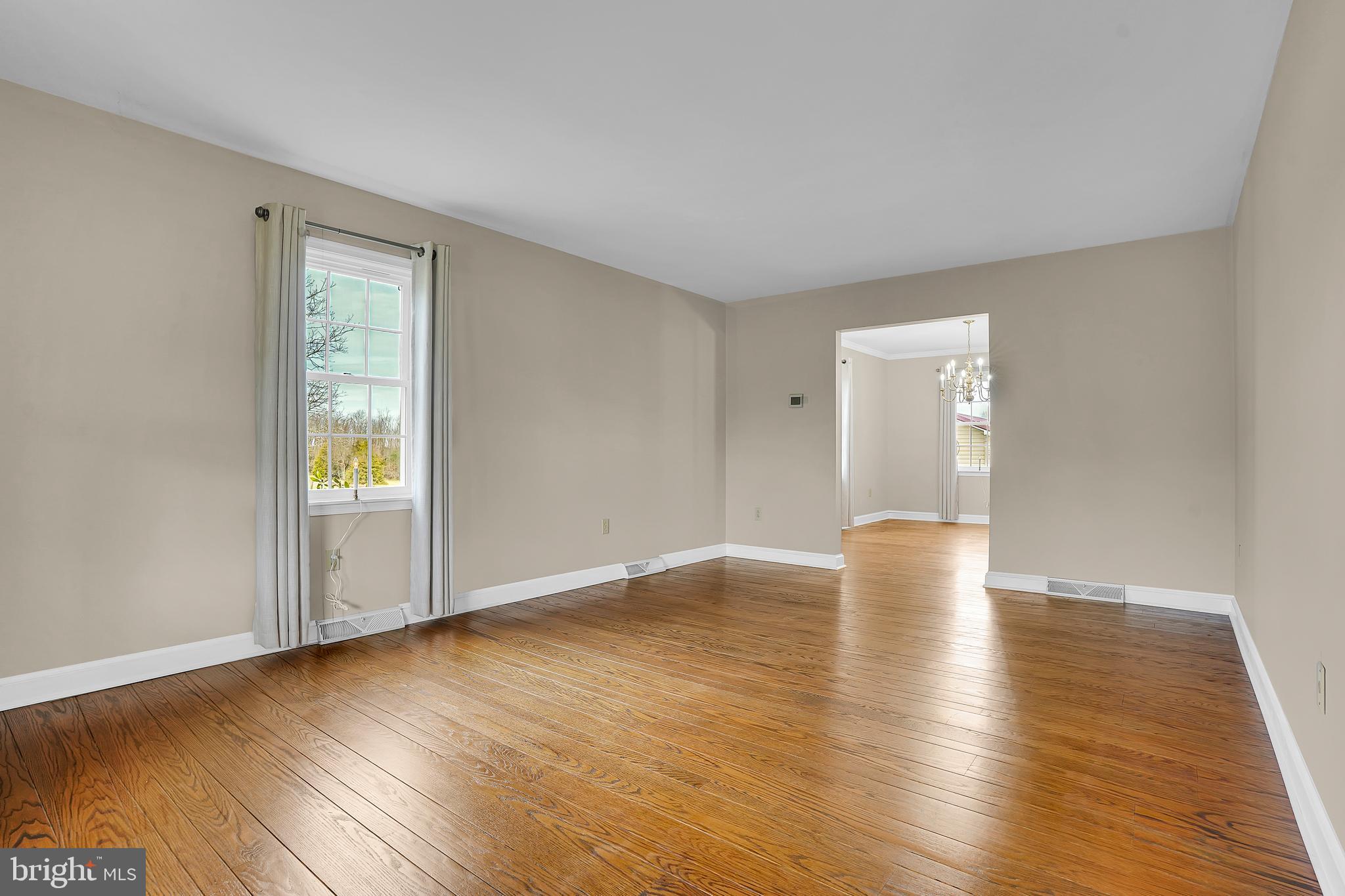 13039 Spickler Road Clear Spring, MD 21722 - Photo 10 of 59 a view of an empty room with wooden floor and a window