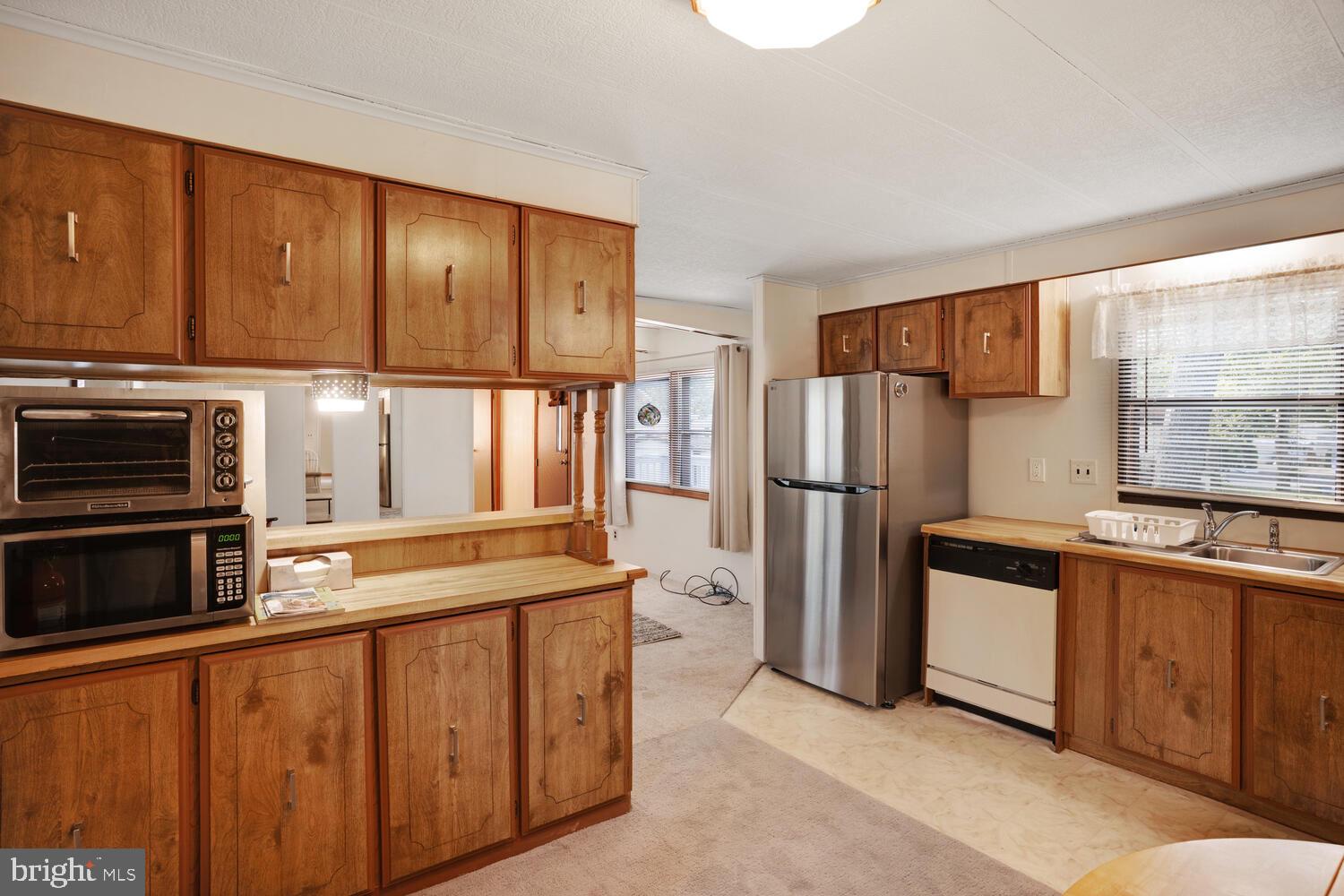34 Holly Road West Creek, NJ 08092 - Photo 16 of 28 a kitchen with stainless steel appliances granite countertop a refrigerator a stove a sink and a microwave