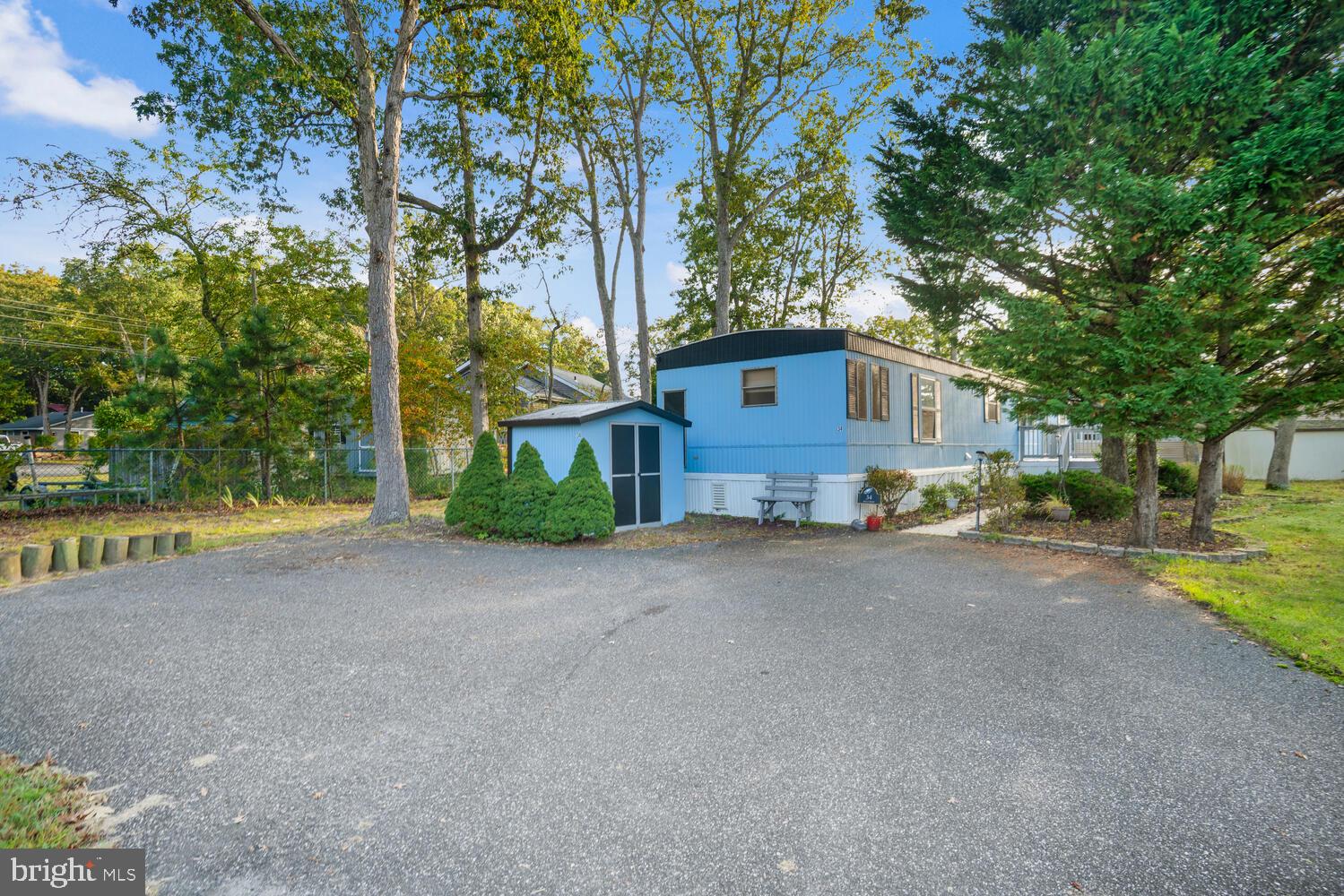 34 Holly Road West Creek, NJ 08092 - Photo 2 of 28 a view of a house with large tree and wooden fence