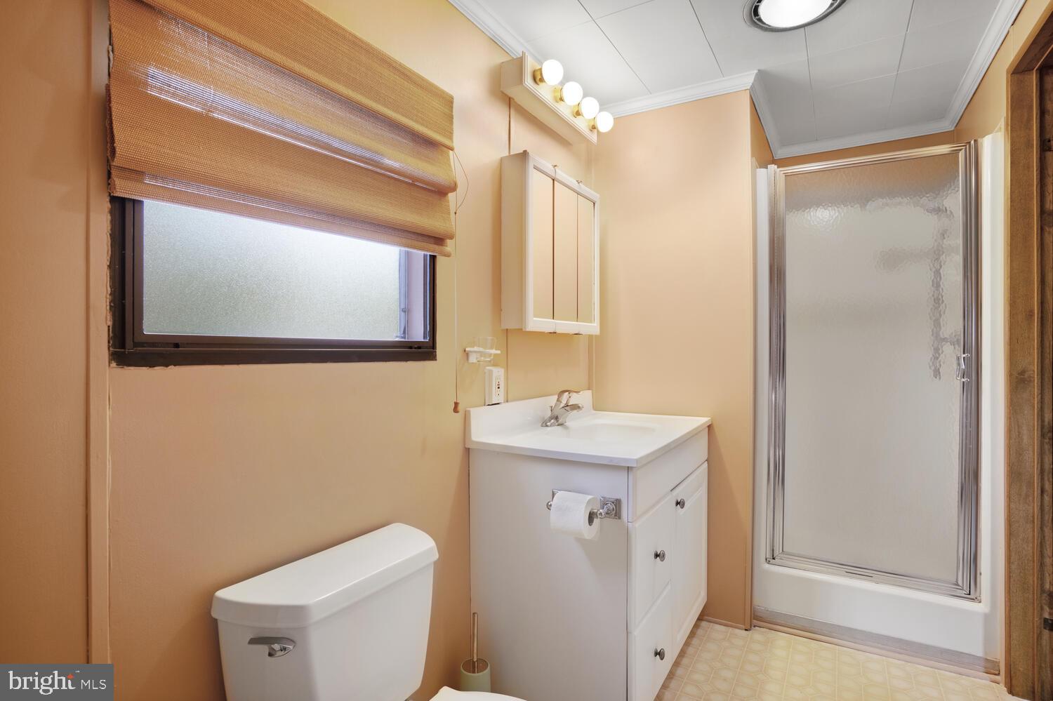 34 Holly Road West Creek, NJ 08092 - Photo 24 of 28 a bathroom with a toilet a sink and mirror