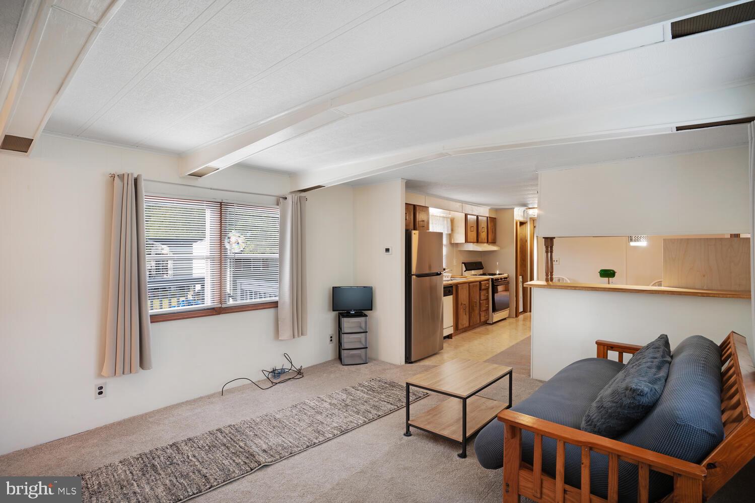 34 Holly Road West Creek, NJ 08092 - Photo 10 of 28 a living room with furniture a flat screen tv and a window
