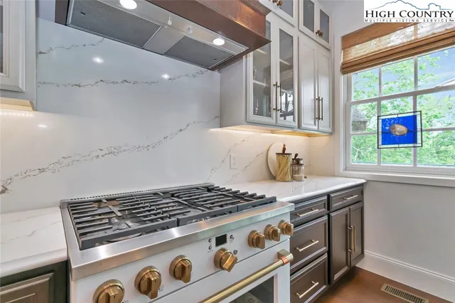 a stove top oven sitting inside of a kitchen