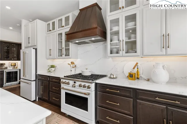 a kitchen with stainless steel appliances granite countertop a stove and a refrigerator