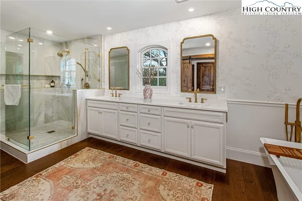 a living room with furniture a rug and a lamp