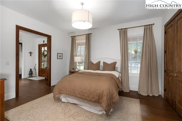 a bedroom with a bed and a mirror