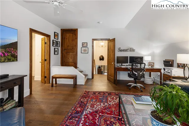 a living room with furniture a rug and a lamp