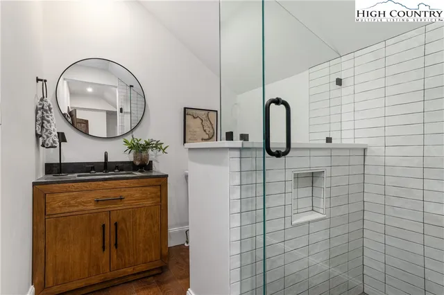 a bathroom with a sink vanity and a mirror