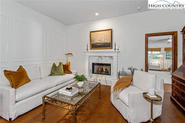 a living room with furniture and kitchen view