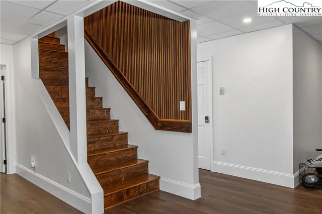 a view of entryway with wooden floor and stairs