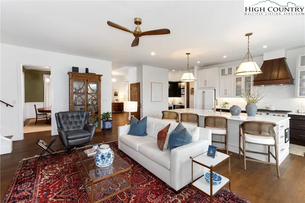 a kitchen with stainless steel appliances a table chairs and a stove