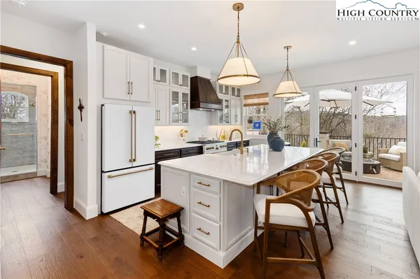 a kitchen with stainless steel appliances granite countertop a stove and a refrigerator