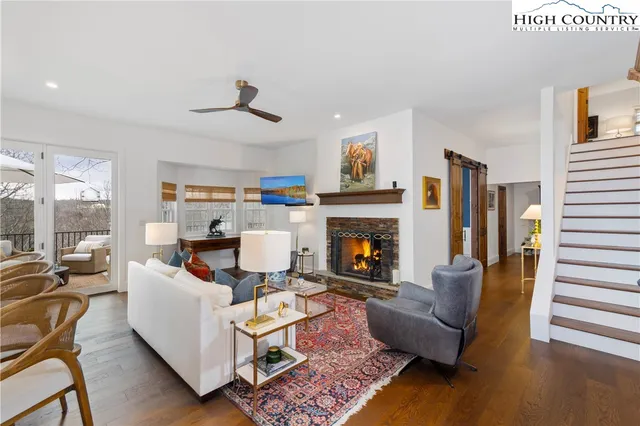 a living room with furniture fireplace and window