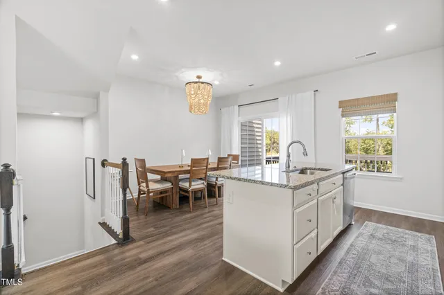 a kitchen with sink cabinets and wooden floor