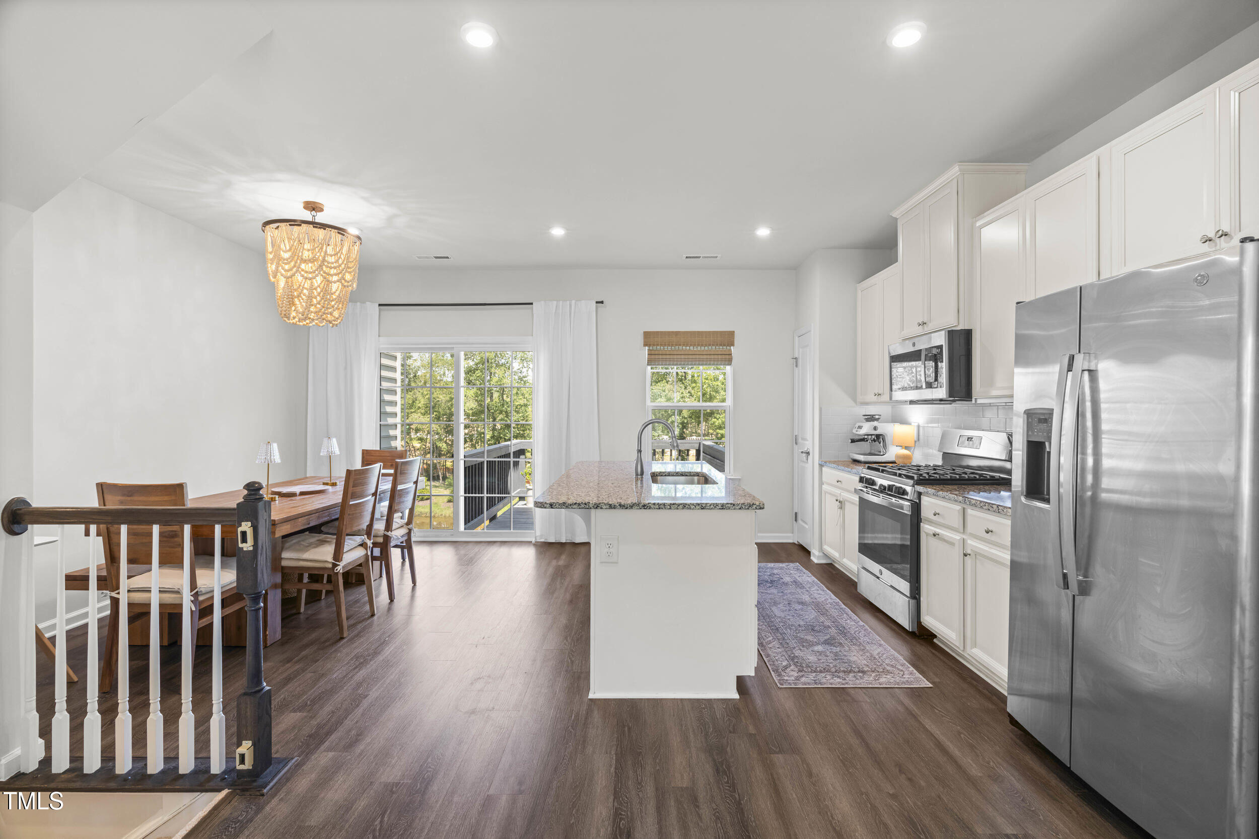 6607 Pathfinder Way Raleigh, NC 27616 - Photo 21 of 37 a large kitchen with a table chairs refrigerator and window